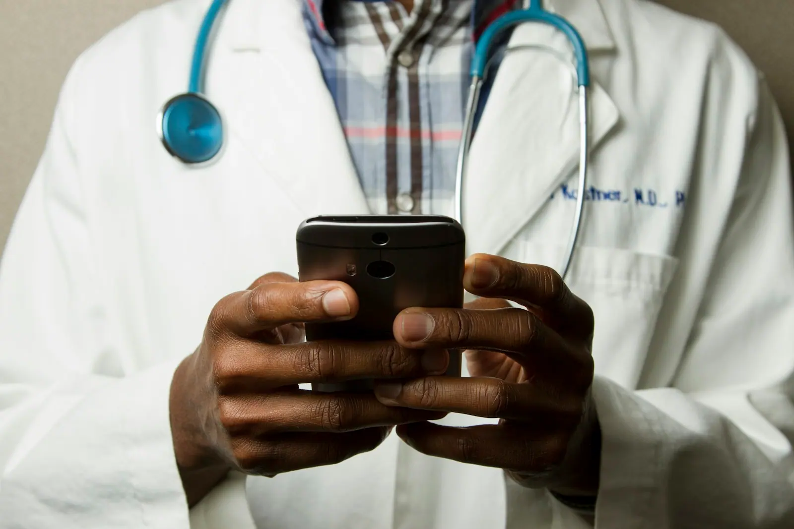 Clinician reviewing a digital record in a bright hospital corridor